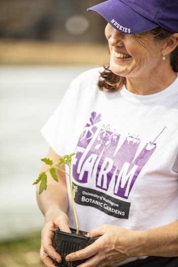a person holding a plant seedling