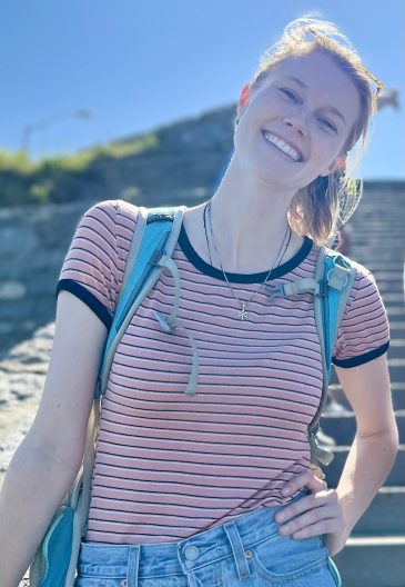 person smiles outdoors