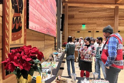 Students and faculty admire the creations from a gingerbread competition.