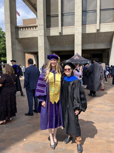 Laura Prugh with PhD graduate Katie Breen outside of Kane Hall on the University of Washington campus.