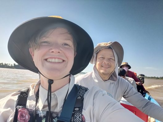 A boat of people on the Mekong River in Southeast Asia.